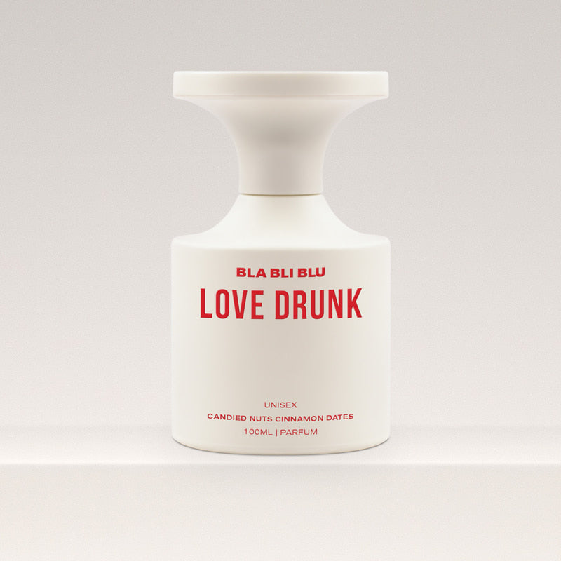 Perfume bottle labeled 'LOVE DRUNK' by BLA BLI BLU on a white background