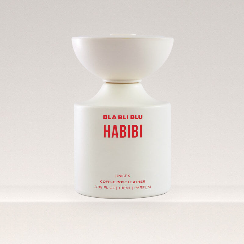 White perfume bottle with red text on a light gray background