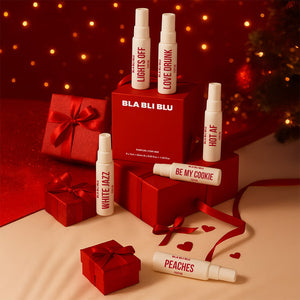 BLA BLU perfume bottles and packaging on a festive background with red ribbons and lights.