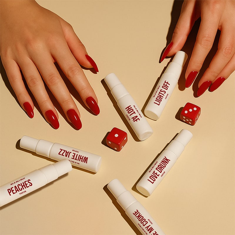 Lip gloss tubes with text and red dice on a beige background