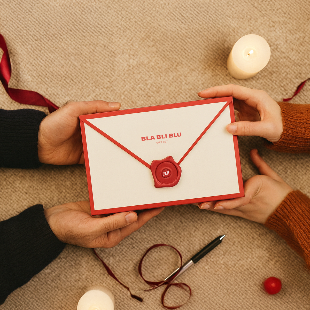 Two hands holding a red and white card with 'BLA BLI BLU' branding on a textured surface.