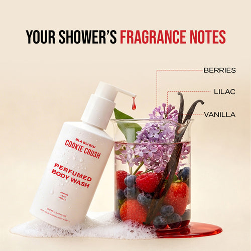 Perfumed body wash bottle labeled 'Cookie Crush' with a glass of berries, lilac, and vanilla on a beige background.