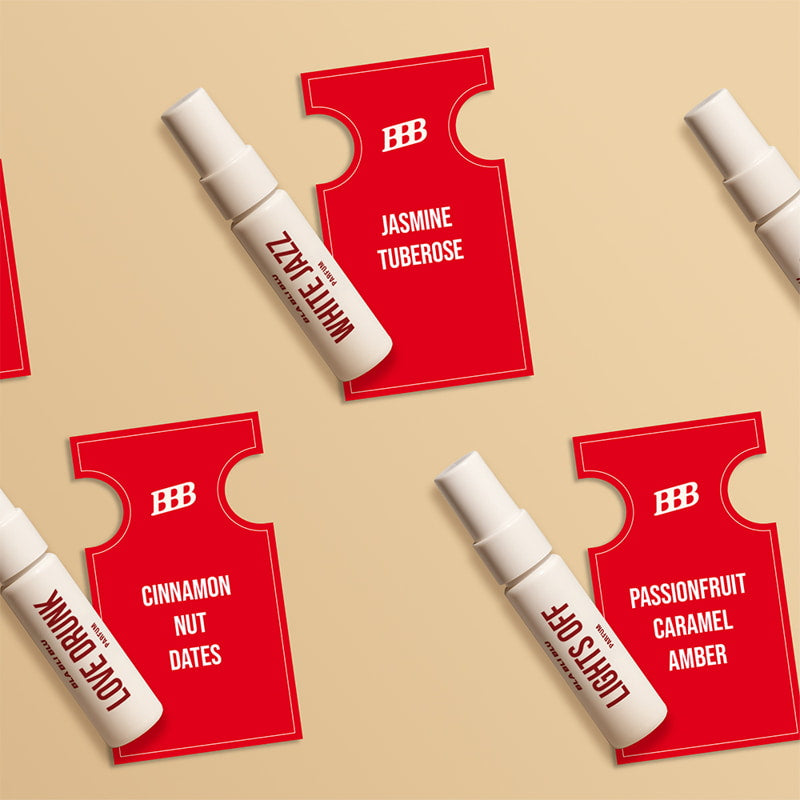 Red perfume bottles with white caps on a beige background