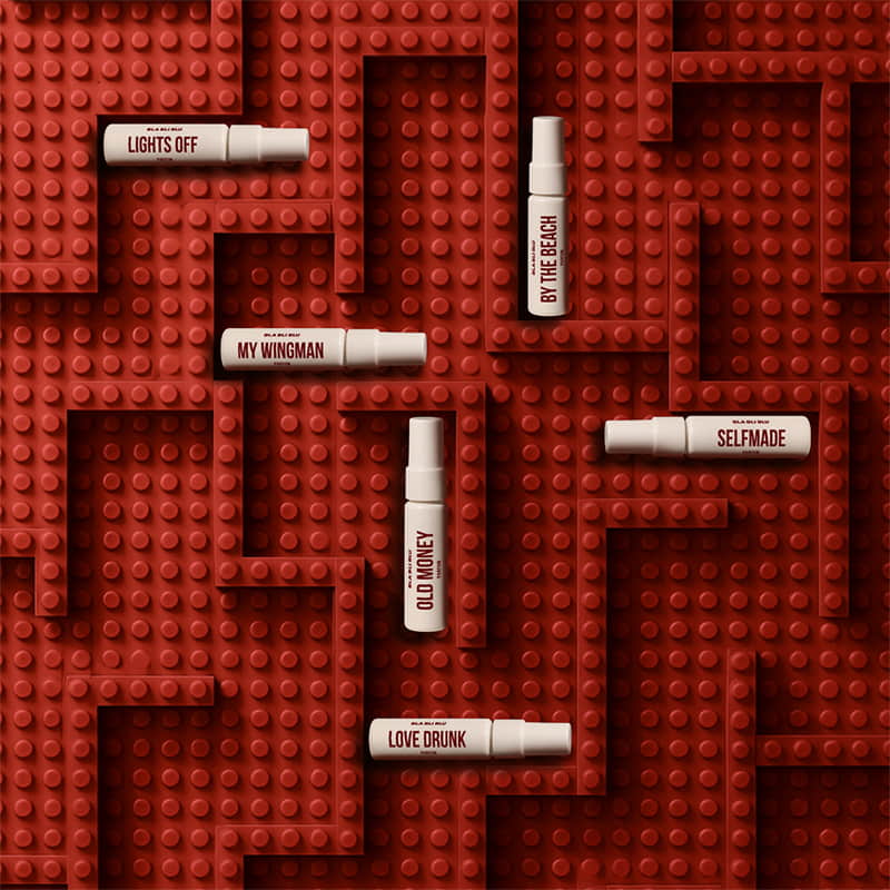 Set of small bottles with labels on a red brick-like surface