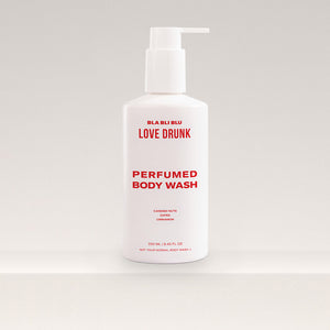 Perfumed body wash bottle with pump on a light gray background