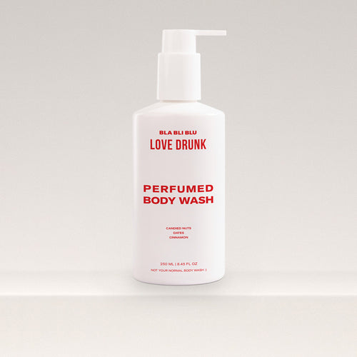 Perfumed body wash bottle with pump on a light gray background