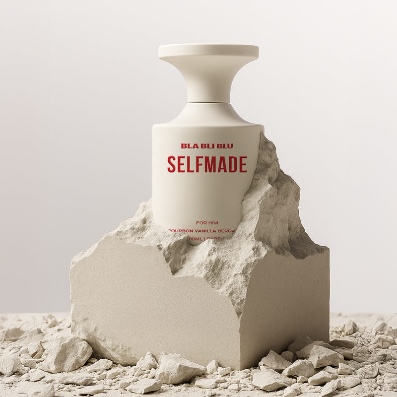 Bottle of BLA BLU BLU Selfmade perfume on a rocky surface with a neutral background