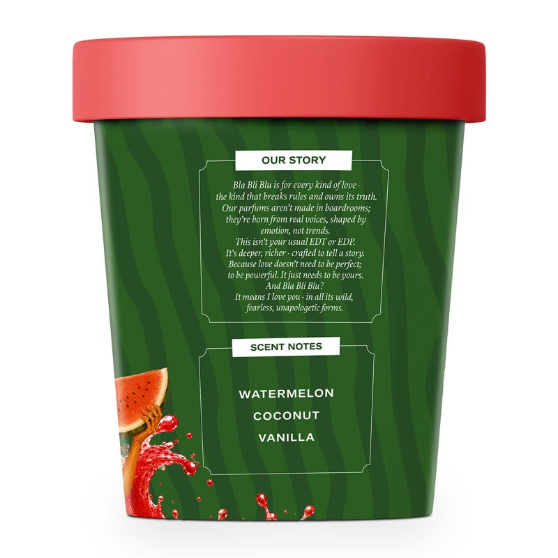 A watermelon-themed scented candle in a cylindrical green container with a red lid. 