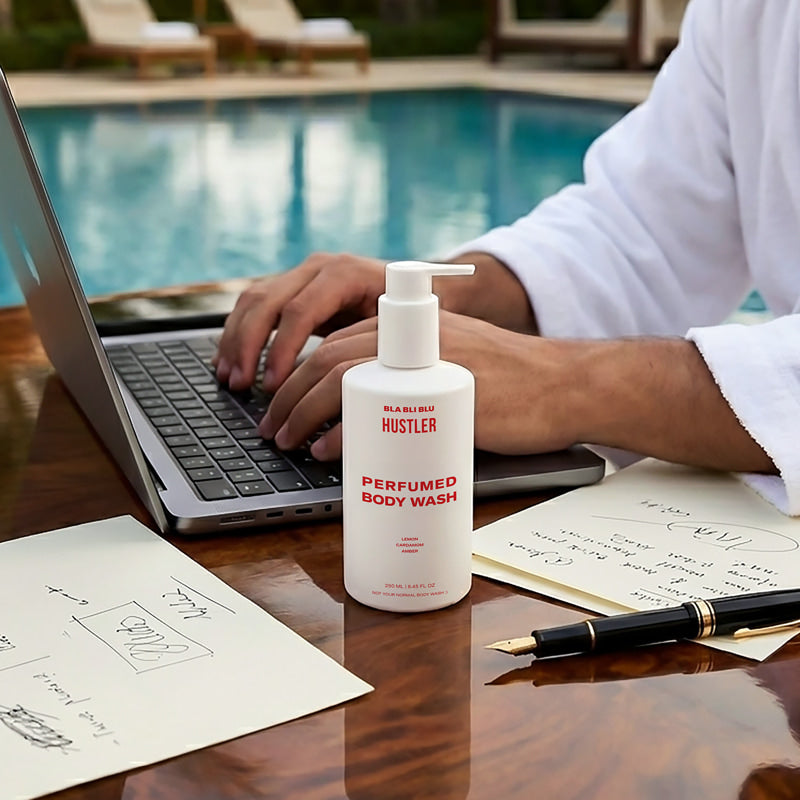 Bottle of Hustler Perfumed Body Wash on a desk by a pool.