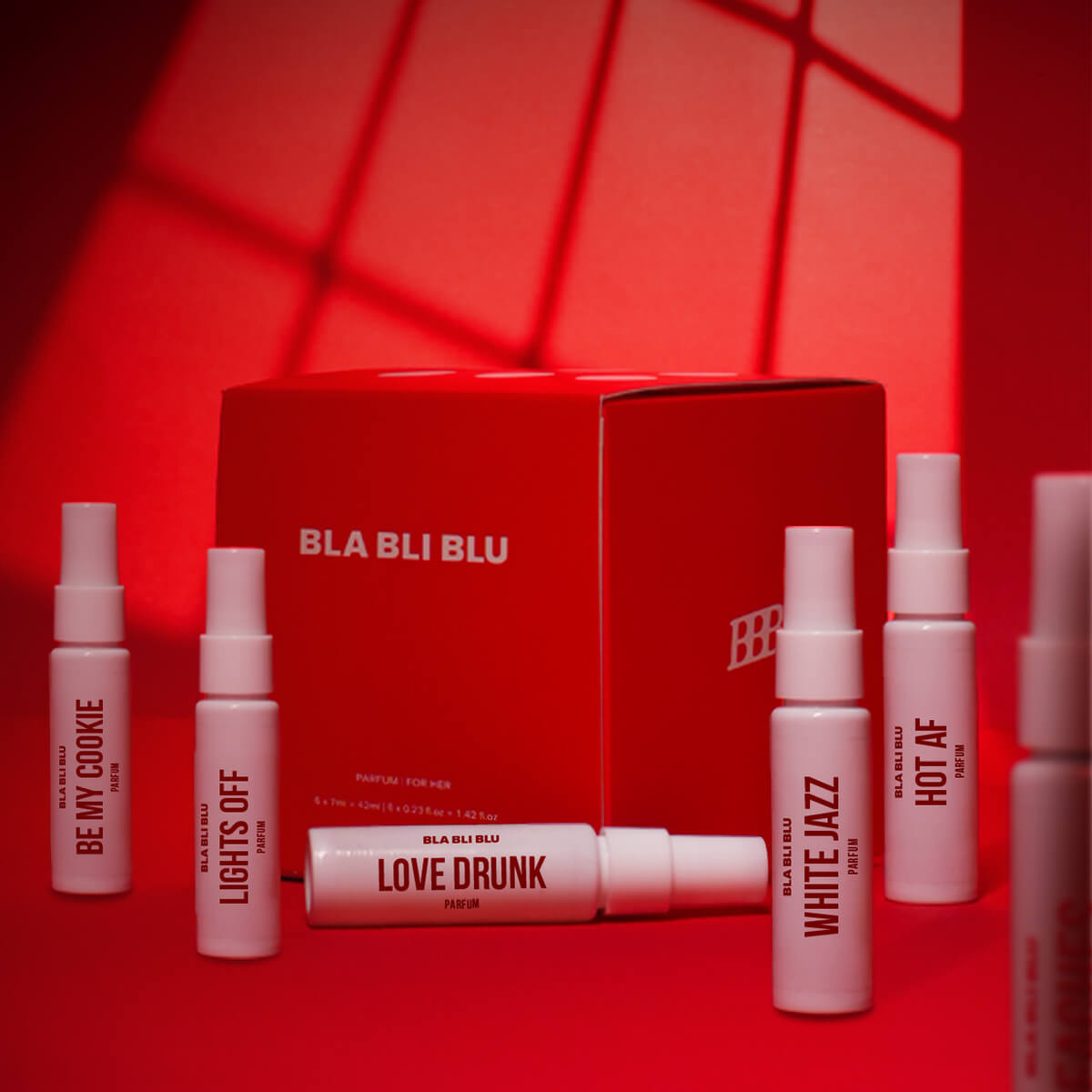 BLA BLI BLU perfume set with various bottles on a red background