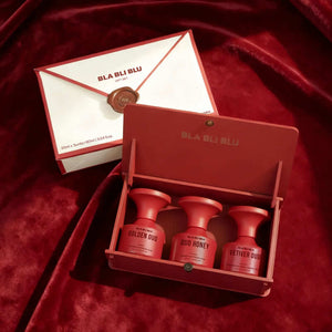 Red 'BLA BLU' skincare product set on a red fabric background